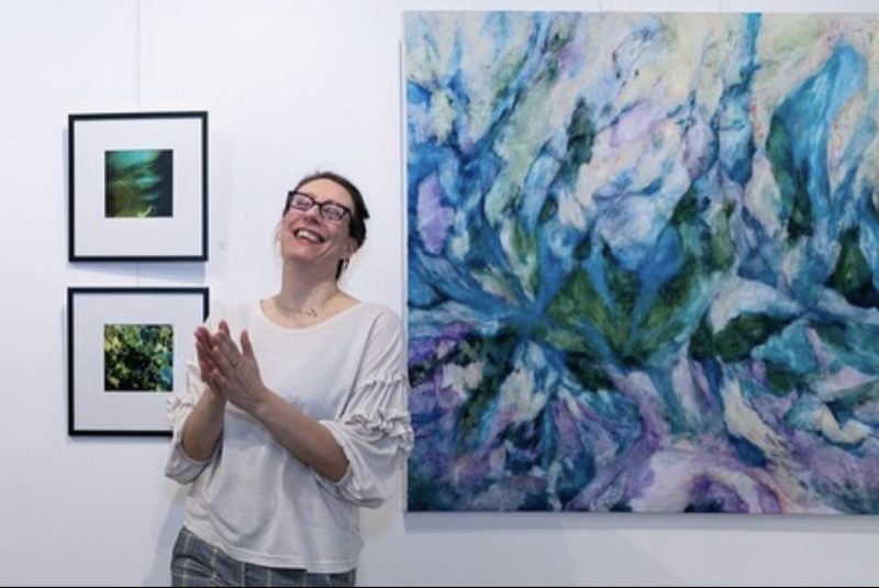 Artist Pernilla Persson next to her 2 artworks 
